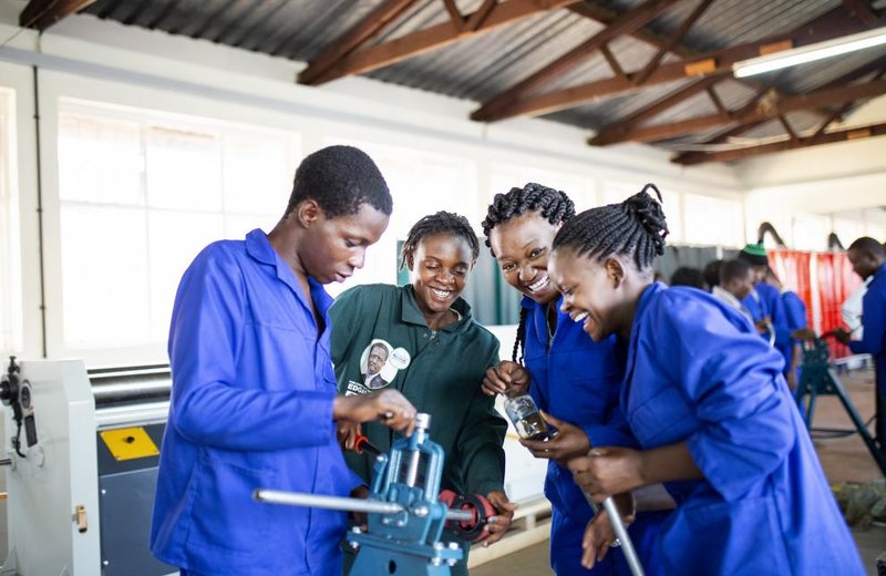 Young people learning hands-on vocational skills in a training workshop